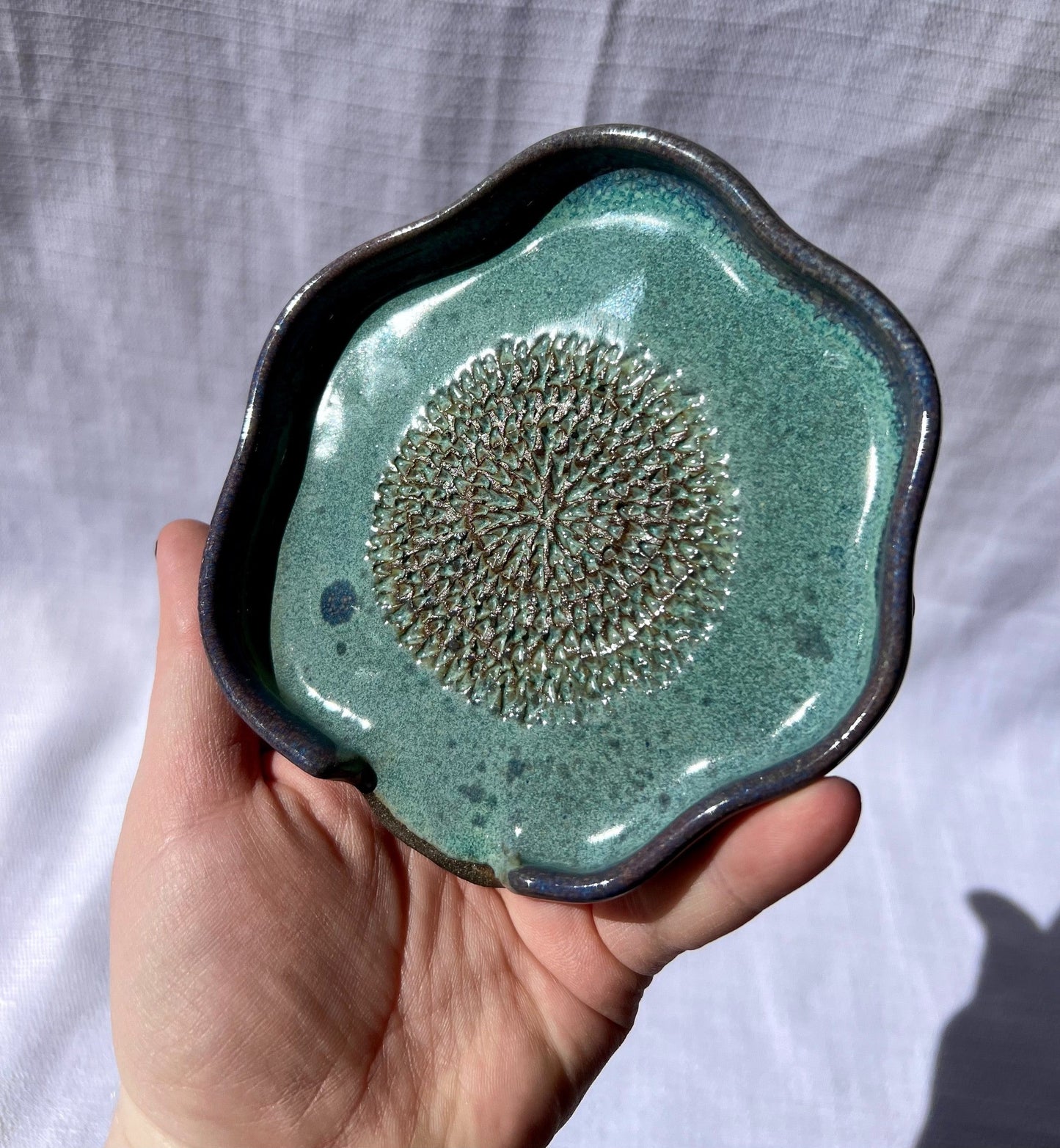 Handmade ceramic garlic grater and spoon rest pottery project made in a San Antonio clay workshop.